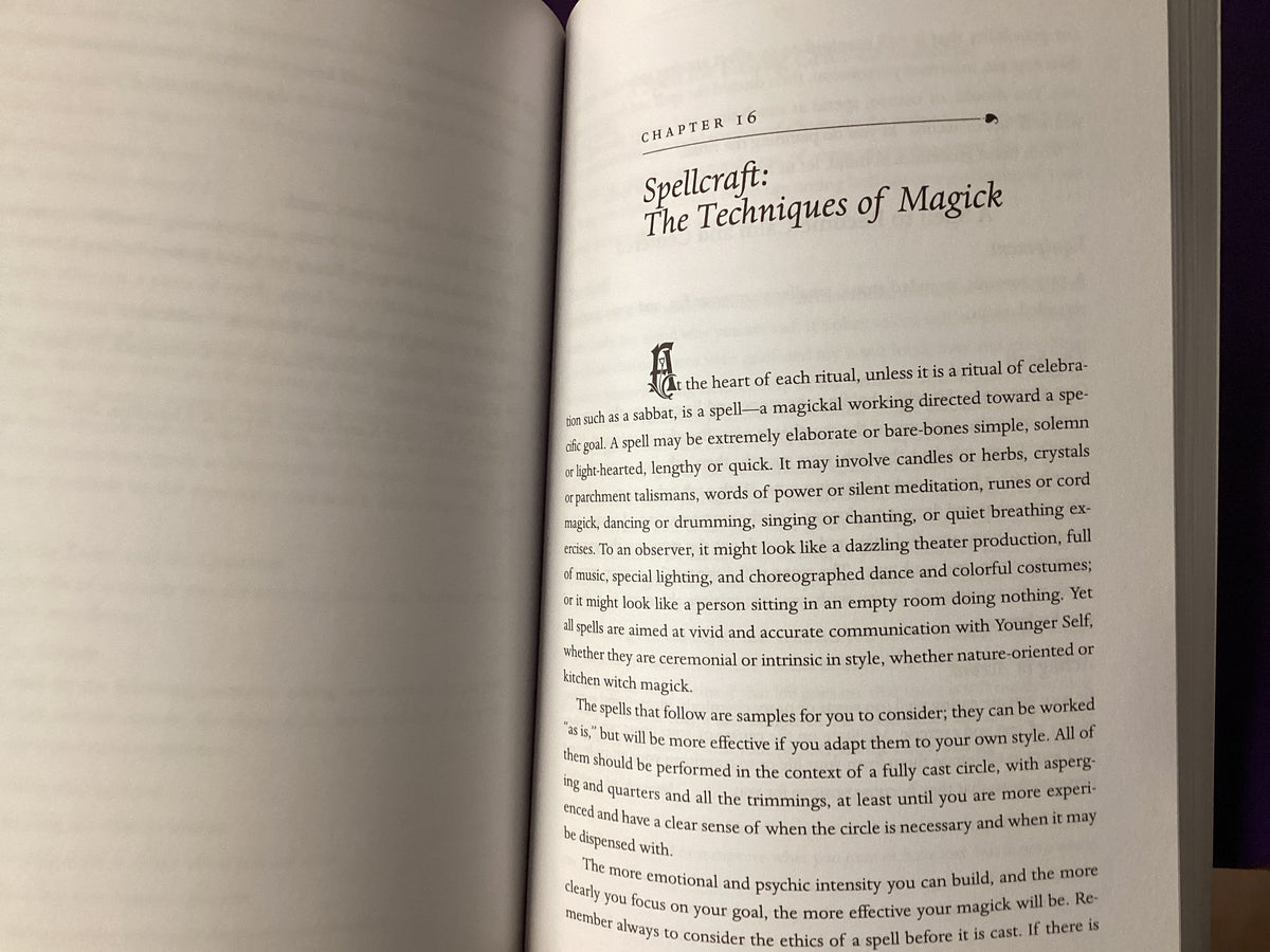 An open book showing a printed page with the heading 'Chapter 16: Spellcraft: The Techniques of Magick' and paragraphs of black text on off-white paper.