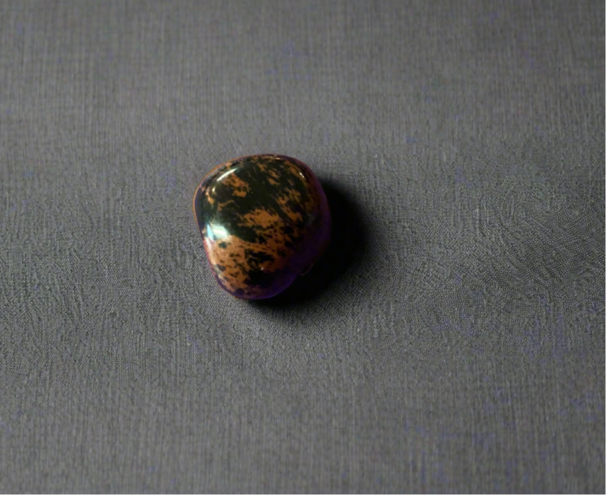 Red Obsidian, also known as Mahogany Obsidian, is a grounding and protective stone connected to the root chakra. It