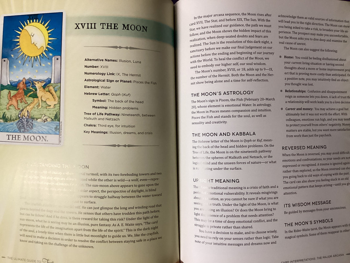 An open book spread showing pages titled 'XVIII THE MOON' with astrological text, a sun illustration, and a small moon-and-tower illustration.
